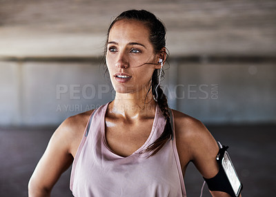 Buy stock photo Cropped shot of an attractive young female athlete working out in the city