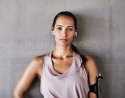 Buy stock photo Cropped portrait of an attractive young female athlete working out in the city