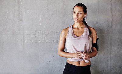 Buy stock photo Cropped shot of an attractive young female athlete working out in the city