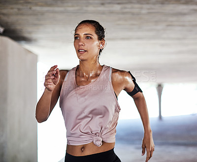 Buy stock photo Cropped shot of an attractive young female athlete working out in the city