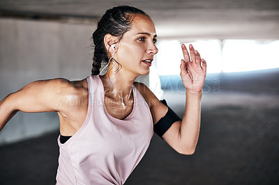 Buy stock photo Cropped shot of an attractive young female athlete working out in the city