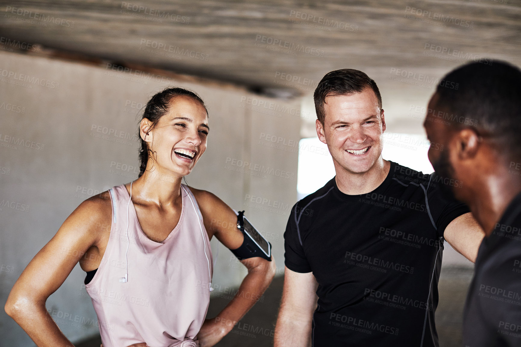 Buy stock photo Cropped shot of three young athletes talking while working out in the city