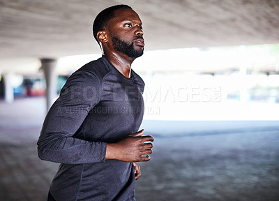Buy stock photo Cropped shot of a handsome young male athlete working out in the city