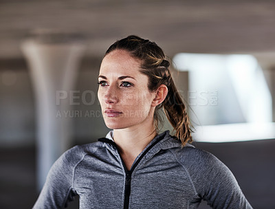 Buy stock photo Cropped shot of an attractive young female athlete working out in the city