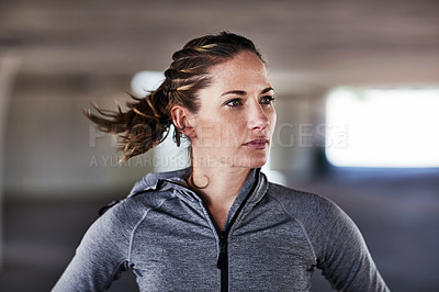 Buy stock photo Cropped shot of an attractive young female athlete working out in the city