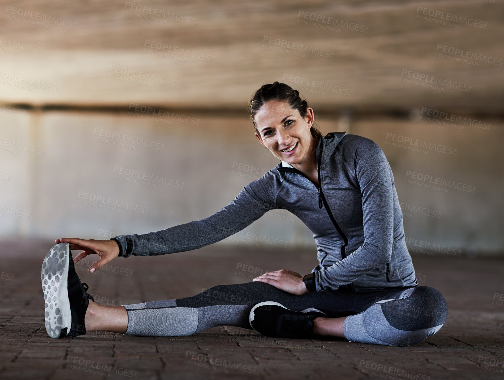 Buy stock photo Full length portrait of an attractive young female athlete stretching during her workout in the city