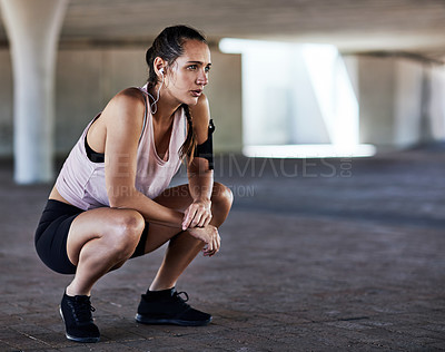 Buy stock photo Full length shot of an attractive young female athlete resting during her workout in the city