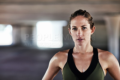 Buy stock photo Cropped portrait of an attractive young female athlete working out in the city