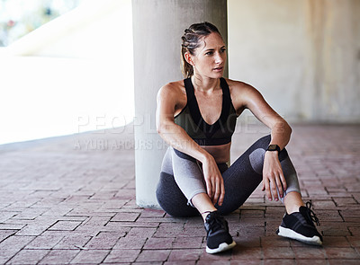 Buy stock photo Full length shot of an attractive young female athlete resting during her workout in the city