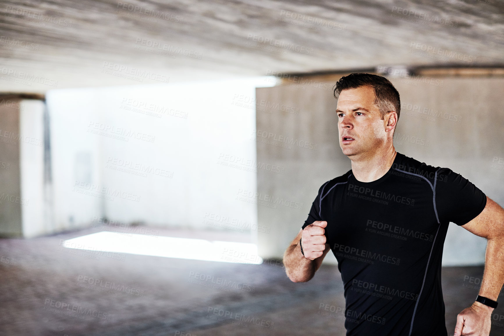 Buy stock photo Cropped shot of a handsome young male athlete working out in the city