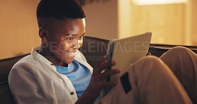 Buy stock photo Smile, tablet and gamer or black child on sofa in home for esports app, streaming service and night. Online gaming platform, relax and entertainment with kid in living room of apartment for hobby