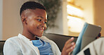 Smile, tablet and gamer with black child on sofa in home for esports app, streaming service and media. Online gaming platform, relax and entertainment with kid in living room of apartment for hobby