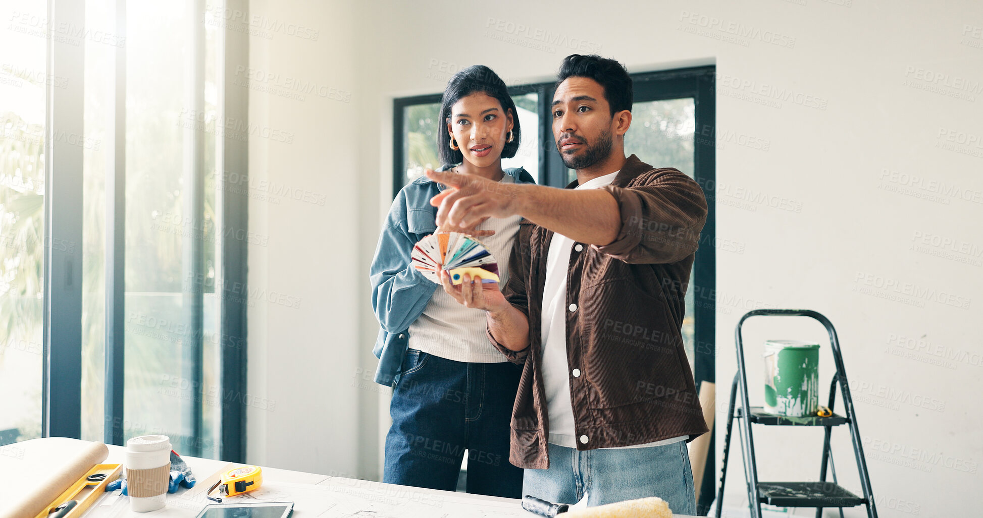 Buy stock photo Color palette, DIY and pointing with couple at table in home for discussion or project planning. Decision, real estate investment and swatch with people in new house for interior design or vision
