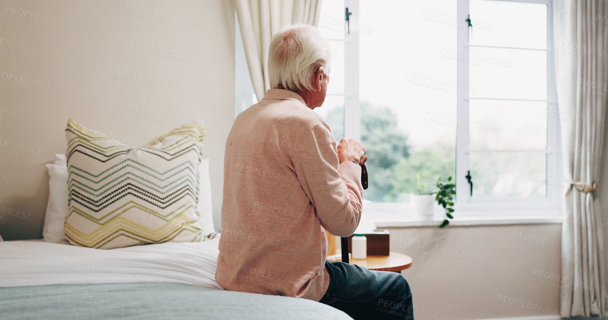 Buy stock photo Thinking, window and senior man in bedroom at house for reflection, remember or retirement memory. Walking stick, nostalgia and elderly person with dementia on bed with ideas for pension in home.