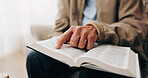 Senior, hands and reading with bible for faith, religion or worship for spiritual wellness in home. Elderly, male person or holy book with god, scripture or gospel for christianity, praying or belief