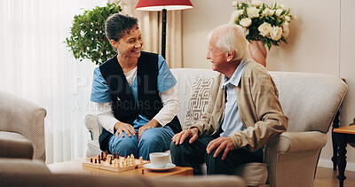Buy stock photo Happy, talking and nurse with senior man on sofa in home for medical assistance, help or checkup. Smile, conversation and caregiver with elderly patient in retirement for consultation in living room.