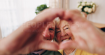 Buy stock photo Portrait, happy and old couple in retirement home with heart hands, bonding together and connection. Married, senior people and smile in living room with love sign, soulmate relationship and loyalty.