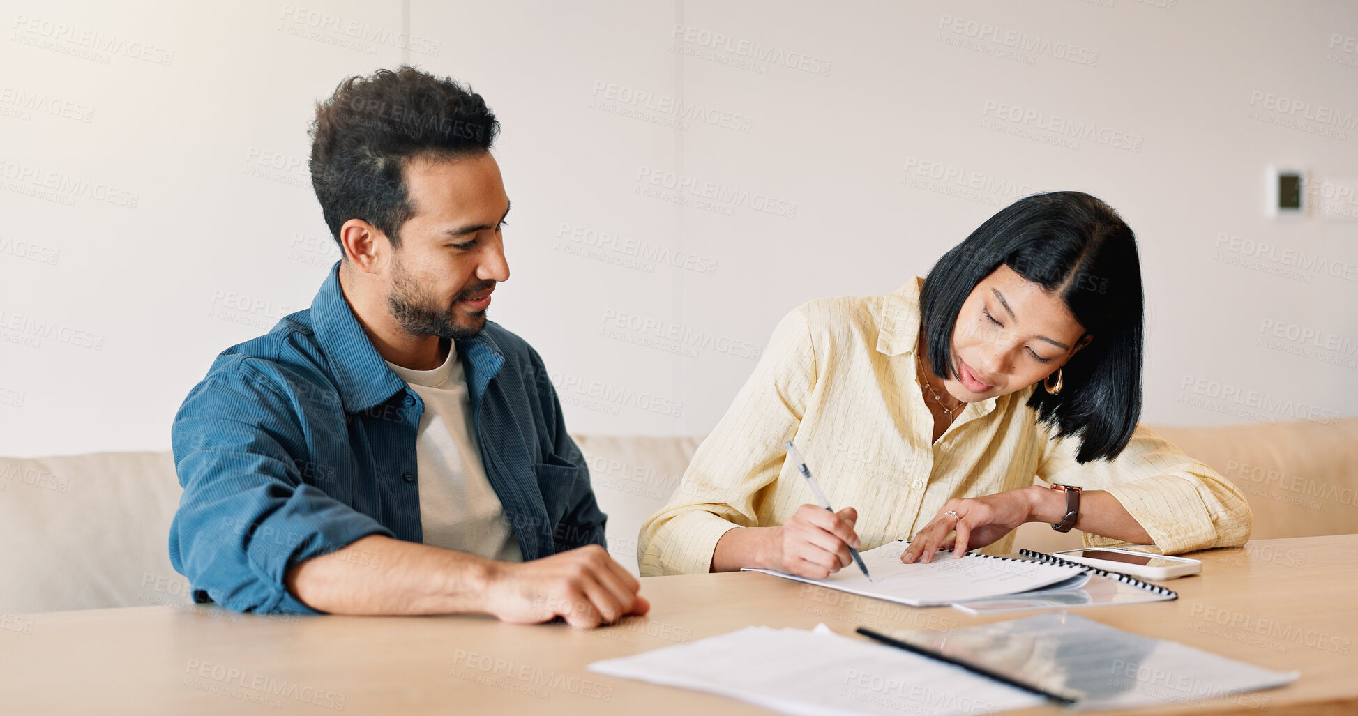Buy stock photo Budget, documents and signature with couple at table in home for insurance or investment. Finance, paperwork and writing with people in apartment together for application, approval or contract