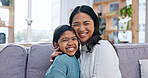 Portrait, mother and child at house with smile, love and parental affection for bonding together. Happy, woman and daughter in home with embrace, connection and childcare for weekend break in lounge