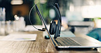 Empty, office and desk with laptop, headset and documents for investment advice at finance agency. Call center, background and computer with mic for financial consulting, crm support and contact us