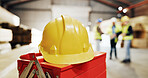 Helmet, warehouse and toolbox with men for carpentry, construction project and building. Site, contractor and hardhat for safety, compliance and ppe for renovation, infrastructure and woodworking