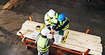 Meeting, blueprint and men with hand stack for carpentry, construction project and agreement. Warehouse, above and people with teamwork for renovation success with woodworking, building and planning