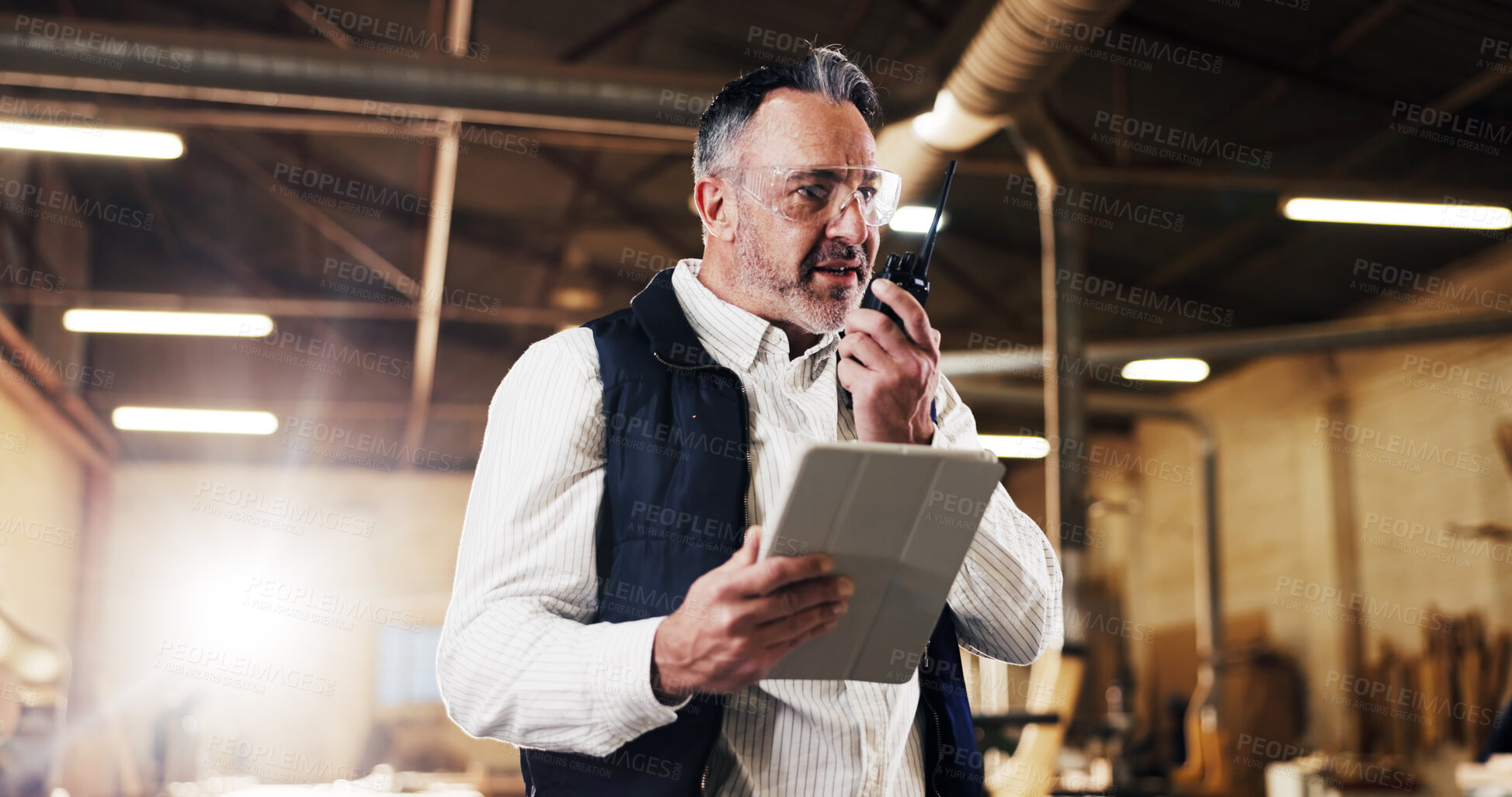 Buy stock photo Radio, inspection and man with tablet in carpentry warehouse for quality control or planning. Manufacturing, timber factory and mature person with tech for workshop, safety and communication or flare