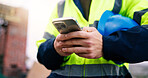 Architect, online and hands with phone on construction site, texting and communication with contact. Civil engineering, chat and person with mobile, low angle and property development update on app