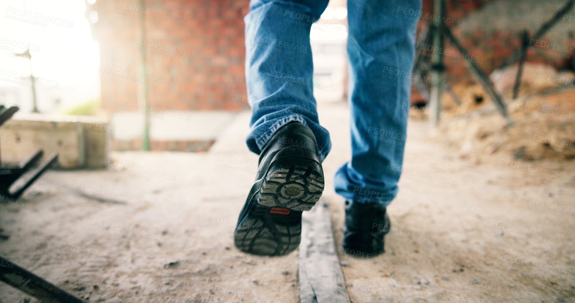 Buy stock photo Man, legs and walk on construction site with civil engineering inspection, renovation or infrastructure. Back, person or engineer in building with work boots, property development and industrial job.
