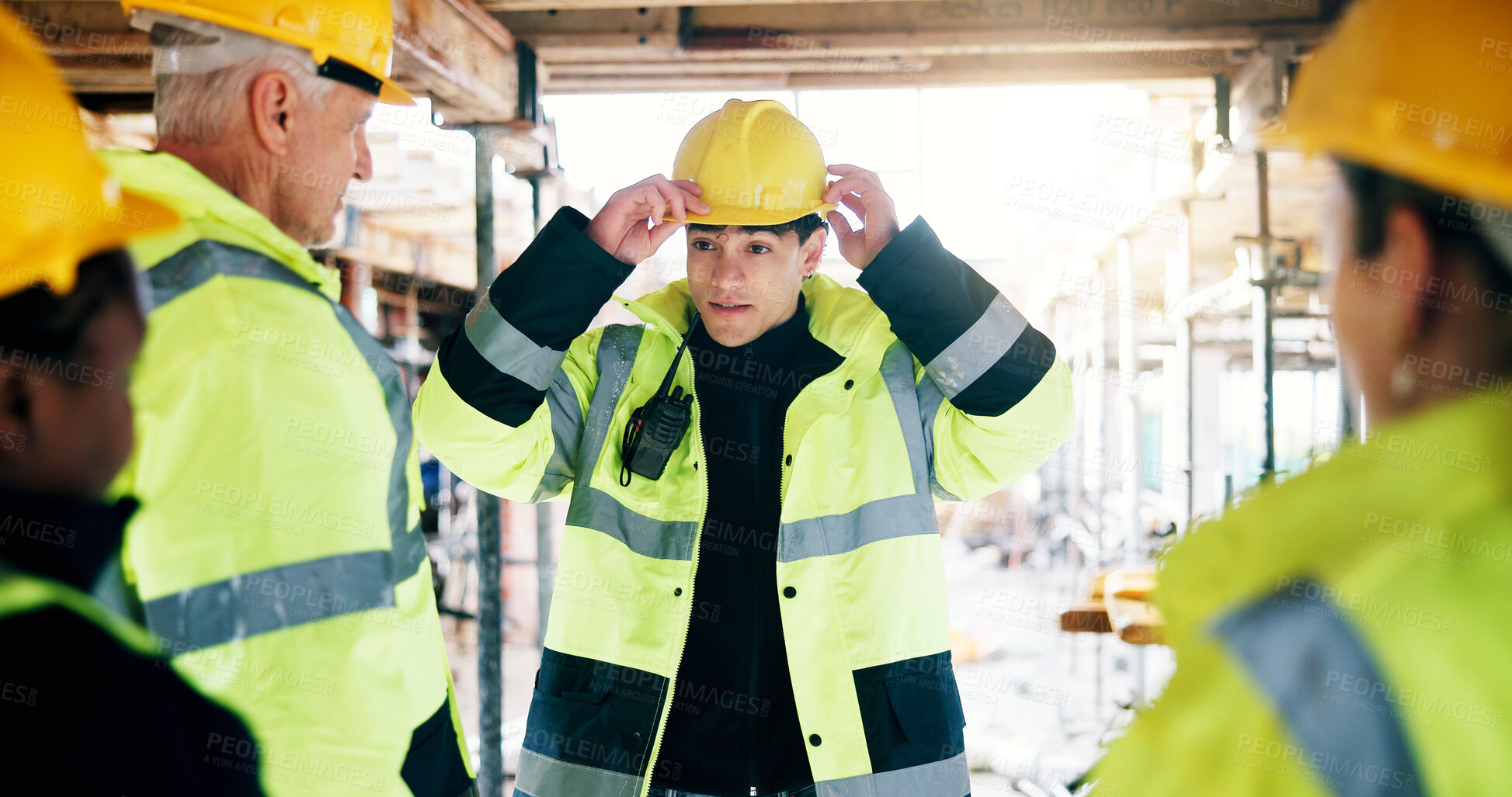 Buy stock photo People, helmet and team on construction site for planning, compliance update and property development. Civil engineer, group and hardhat on worksite for safety protocol, discussion and project rules