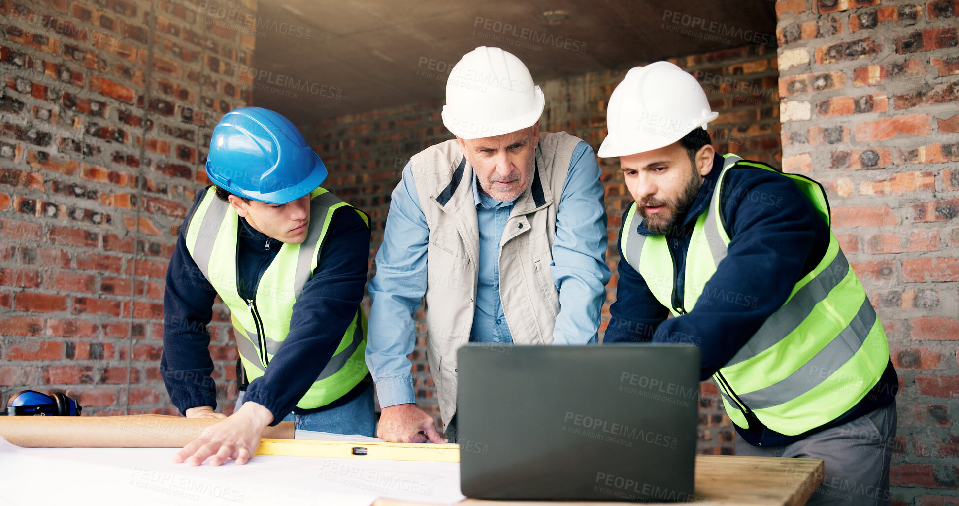 Buy stock photo Engineering, team and meeting on construction site with laptop, blueprint or brainstorming for project. Civil engineer, men and talk in building with computer, plan and research for infrastructure.