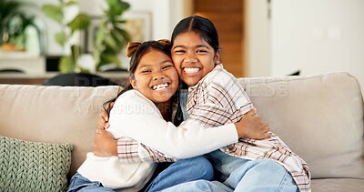 Buy stock photo Hug, sisters and children with love in home, happy girls and bonding together with connection. Portrait, smile and siblings embrace on sofa for support, trust and care with security at family house