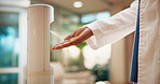 Doctor, hand and sanitizer dispenser in hospital for hygiene, cleaning or healthcare safety protocol. Medical worker, person and disinfectant spray in clinic for disease prevention, germs or bacteria