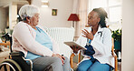Conversation, nurse with tablet and old woman in wheelchair for home checkup or healthcare. App, explain and support with caregiver speaking to senior patient in living room for rehabilitation