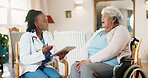 Healthcare, nurse with tablet and old woman in wheelchair for appointment or home visit. Conversation, smile and support with caregiver talking to senior patient with disability for rehabilitation