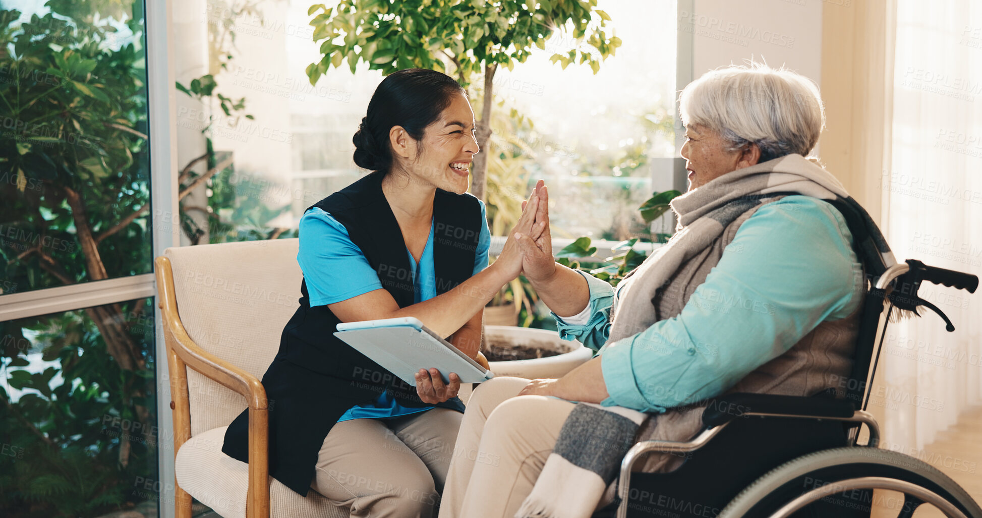 Buy stock photo High five, nurse and tablet with old woman with disability for advice, consulting or results. App, checkup and medical professional talking to senior patient in wheelchair for home rehabilitation