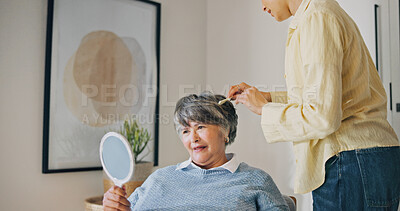 Buy stock photo Haircare, elderly mother or woman in home with mirror, grooming or family bonding in morning routine. Happy, senior mom or daughter with comb, getting ready or hair styling assistance in retirement.