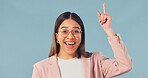 Business, woman and pointing in studio with surprise, advertising and sign up for job interview. Portrait, space and excited with female person, announcement and gesture for hiring on blue background