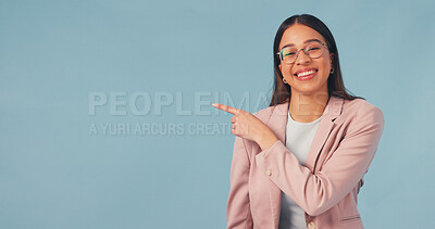 Buy stock photo Happy, business and woman point in studio, advertising and announcement for job interview. Portrait, mockup space or smile with person, b2b sign up and hand gesture for recruitment on blue background