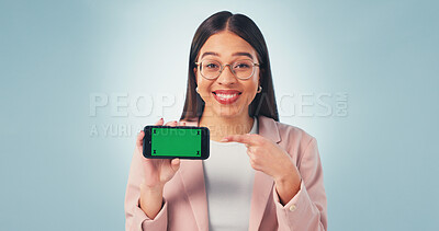 Buy stock photo Pointing, green screen and portrait of businesswoman with phone in studio for advertising finance app. Happy, mockup space or financial advisor with cellphone for internet banking on blue background.