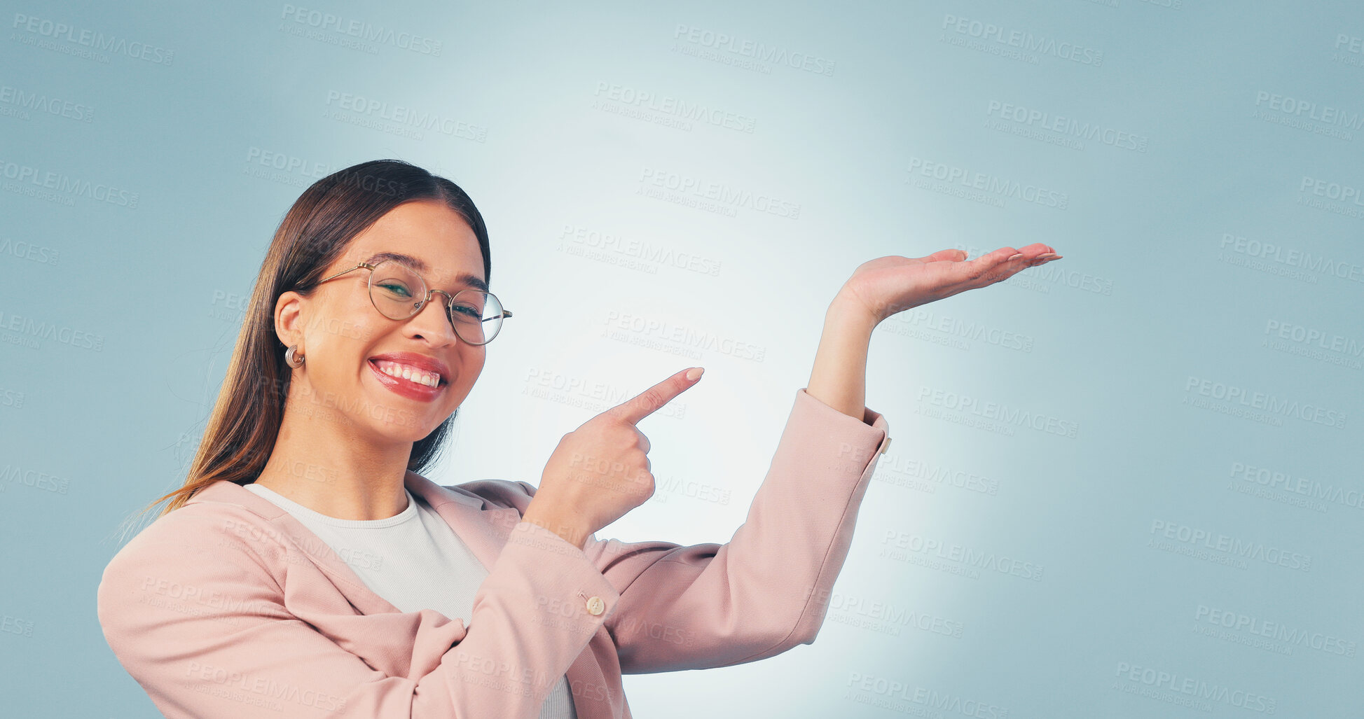 Buy stock photo Portrait, business and woman point in studio, advertising and news for product placement. Smile, space and female person with palm gesture, application and opinion for brand launch on blue background