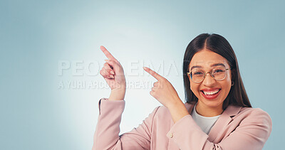 Buy stock photo Portrait, woman and pointing in studio with smile, advertising and announcement for interview. Excited, mockup space or person with gesture, application and opinion for recruitment on blue background