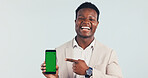 Pointing, green screen and black man with phone in studio for advertising finance mobile app. Happy, portrait and financial advisor with showing cellphone for internet banking on white background.