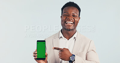 Buy stock photo Pointing, green screen and black man with phone in studio for advertising finance mobile app. Happy, portrait and financial advisor with cellphone mockup for internet banking on white background.