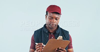 Buy stock photo Logistics, clipboard and delivery man reading in studio with receipt, postal service or customer order. Space, black person and courier with checklist, distribution and shipping on blue background.