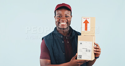 Buy stock photo Portrait, smile and delivery man in studio with boxes, postal service and online shopping package. Happy, black person and courier job for ecommerce order, logistics and space on blue background.