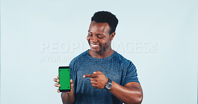 Buy stock photo Man, phone or green screen in studio with pointing for promotion, fitness or social media. Mockup space, gesture or happy black person with tech for app or online exercise program on white background