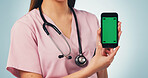Nurse, hands and woman with phone green screen for advertising on a blue studio background. Female person, healthcare worker or smartphone with display for UI, UX or Telehealth app on mockup space