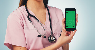 Buy stock photo Nurse, hands and woman with phone green screen for advertising on a blue studio background. Female person, healthcare worker or smartphone with display for UI, UX or Telehealth app on mockup space