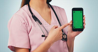 Buy stock photo Nurse, hands and pointing with phone green screen for advertising on a blue studio background. Female person, healthcare worker or showing smartphone display for UI, UX or Telehealth app on mockup